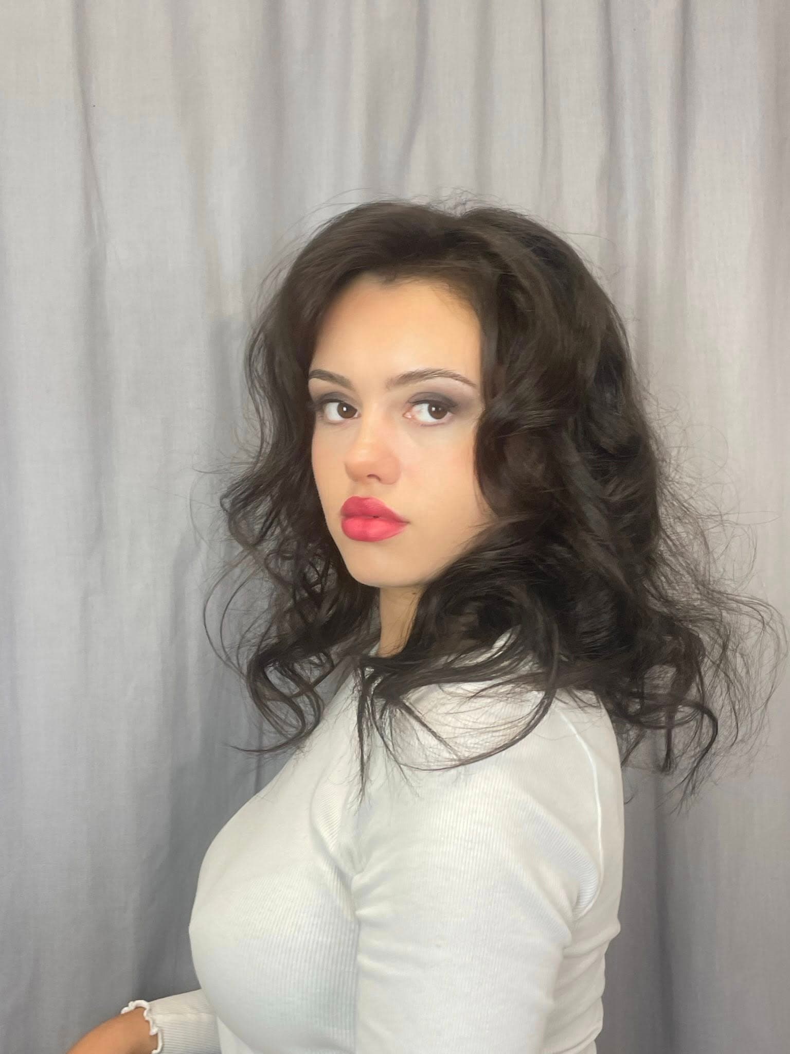 Editorial hair and makeup portrait with soft pink eye makeup.